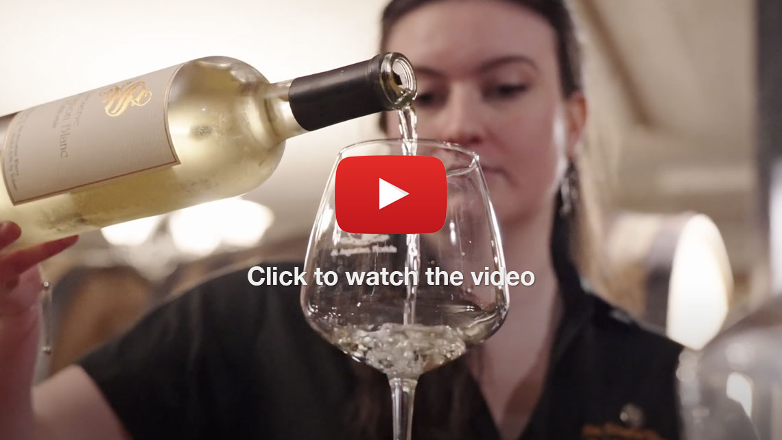 Female pouring wine into a glass